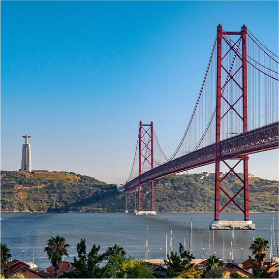 A hotel room with a view of Lisbon out of the window.