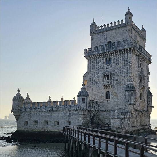 A hotel room with a view of Lisbon out of the window.